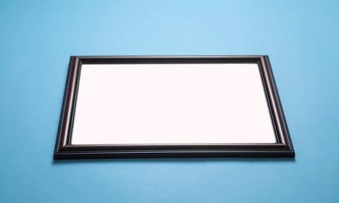 Empty diploma or certificate frame on the blue background. Stock Photos