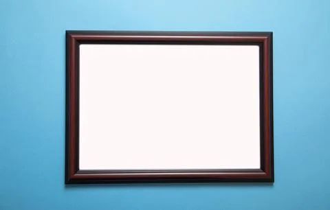 Empty diploma or certificate frame on the blue background. Stock Photos