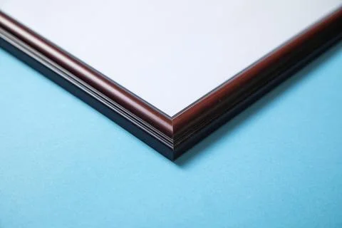Empty diploma or certificate frame on the blue background. Stock Photos