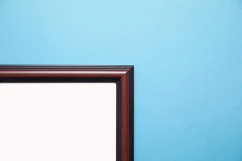 Empty diploma or certificate frame on the blue background. Stock Photos