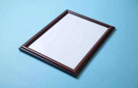 Empty diploma or certificate frame on the blue background. Stock Photos