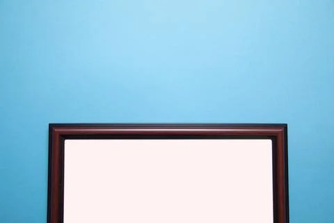 Empty diploma or certificate frame on the blue background. Stock Photos