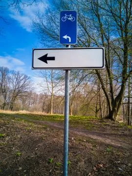 Empty directional sign in a springtime park Stock Photos