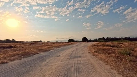 Empty dirt path stretches under bright sun Stock Footage 341776877