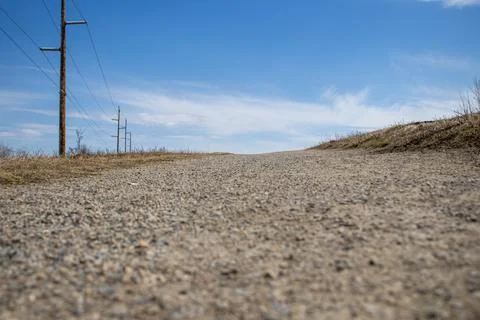 Empty Dirt Road under Clear Blue Sky Stock Photos