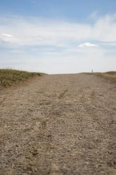Empty Dirt Road under Clear Blue Sky Stock Photos