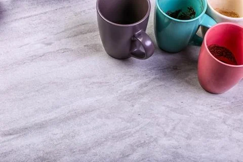 Empty dirty coffee cups of different colors on the table. Concept of caffeine Stock Photos