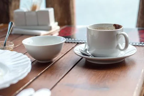 Empty dirty dishes on the table in the cafe after eating, an empty cup of cof Stock Photos