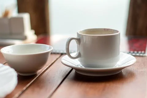 Empty dirty dishes on the table in the cafe after eating, an empty cup of cof Stock Photos