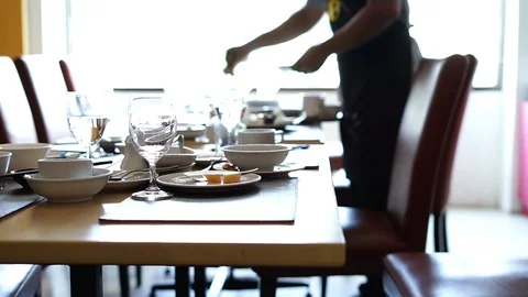 Empty dirty glasses and plates on dinning table in restaurant Stock Footage 128227214