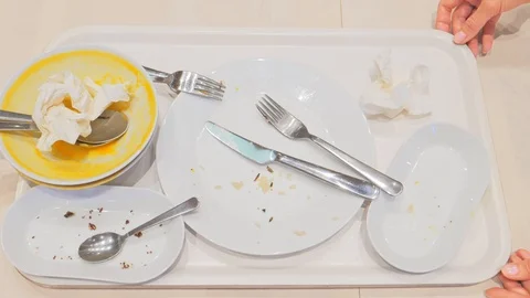 Empty dirty plates with spoon and forks on the table on a tray Stock Footage 112207540