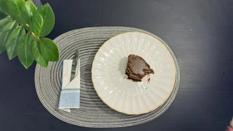 Empty dirty white plate with cake crumbs and fork after finishing dessert, .. Stock-Fotos