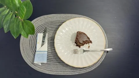 Empty dirty white plate with cake crumbs and fork after finishing dessert, .. Stock-Fotos