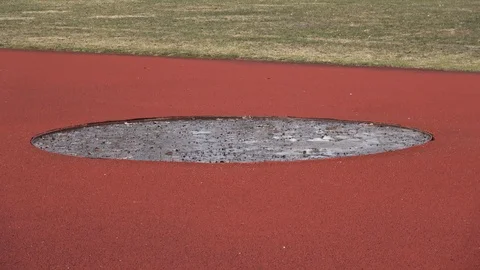 Empty discus throwers direction with  leaves and water in spring 스톡 동영상 104330346