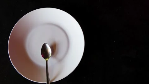 Empty dish and spoon top view on black background with copy space Stock Footage 324704203