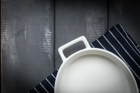 Empty dish for baking on a dark countertop. Stock Photos