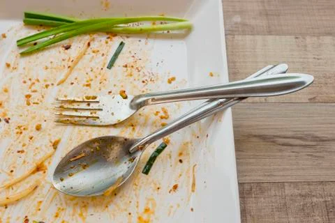 Empty dish but still has spring onion after food on the table Stock Photos