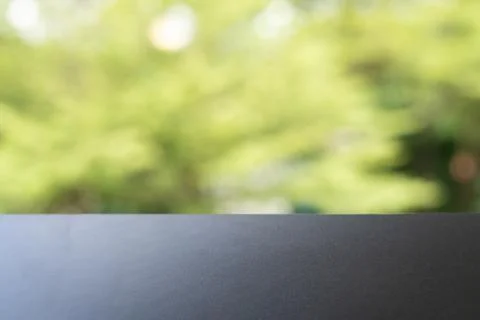 Empty Display Surface with Blurred Green Foliage Background for Product Mocku Stock Photos