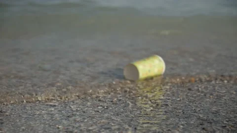 Empty disposable cup in water. pollution of the environment, rivers, seas, ocean Stock Footage 163968494
