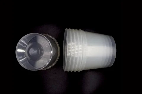 Empty Disposable Plastic Cup, Lying horizontally plastic cup isolated on blac Stock Photos