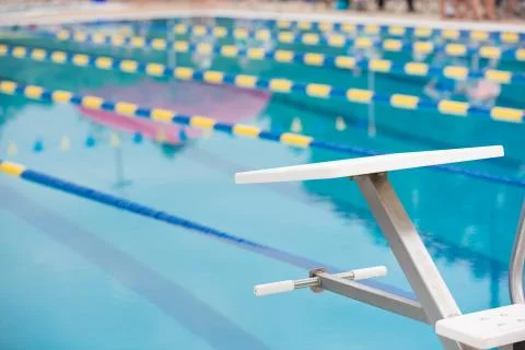 Empty diving block with race lanes in pool Stock Photos