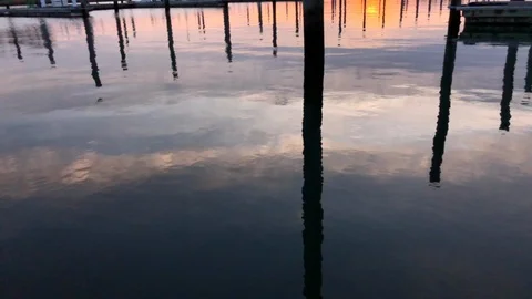Empty Dock reflection in water at sunset Stock Footage 100606338