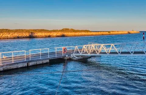 Empty dock for small boats in the light of the setting sun in Lagos, Portugal Stock Photos