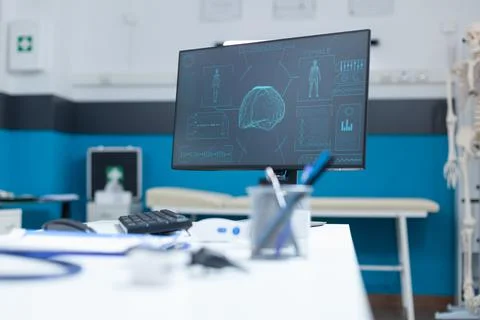 Empty doctor office with computer having anatomical body skeleton radiography Stock Photos