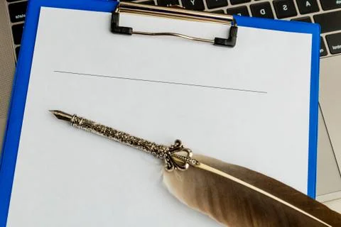 An empty document and pen on the tablet on the desk. Stock Photos