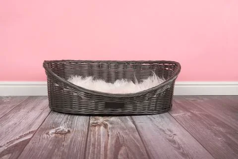 Empty dog bed on a pink background Stock Photos