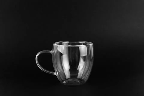 Empty double wall glass cup mug isolated on a black background Stock Photos
