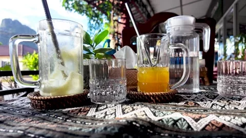 Empty drink glasses on table in Vang Vieng cafe. pushf forward shot Stock Footage 321793465