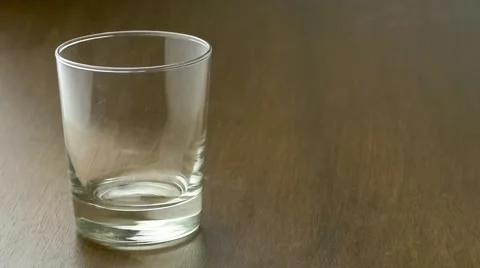 Empty drinking glass filling up with a stream of fruity blackcurrant flavored. Stock Footage 62938086