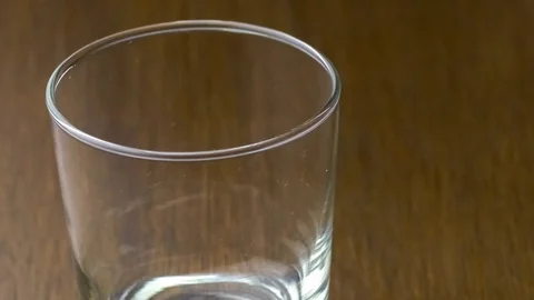 Empty drinking glass filling up with stream of fresh orange breakfast juice.. Stock Footage 75392683