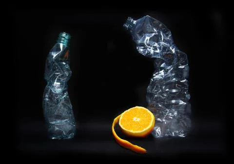 Empty drinking plastic bottle garbage for recycle with fresh orange still lif 写真素材