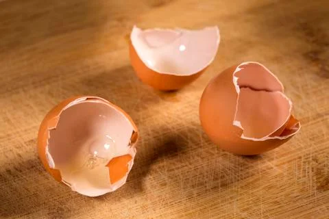 Empty egg shells on wooden cutting board Stock Photos