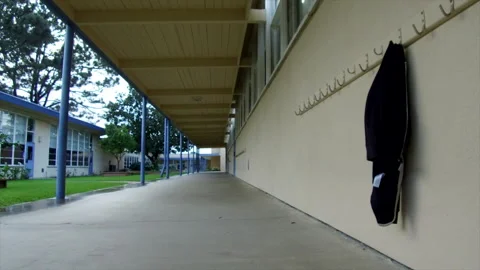 Empty Elementary School Hallway With Single Childs Coat On Hook Stock Footage 130677463