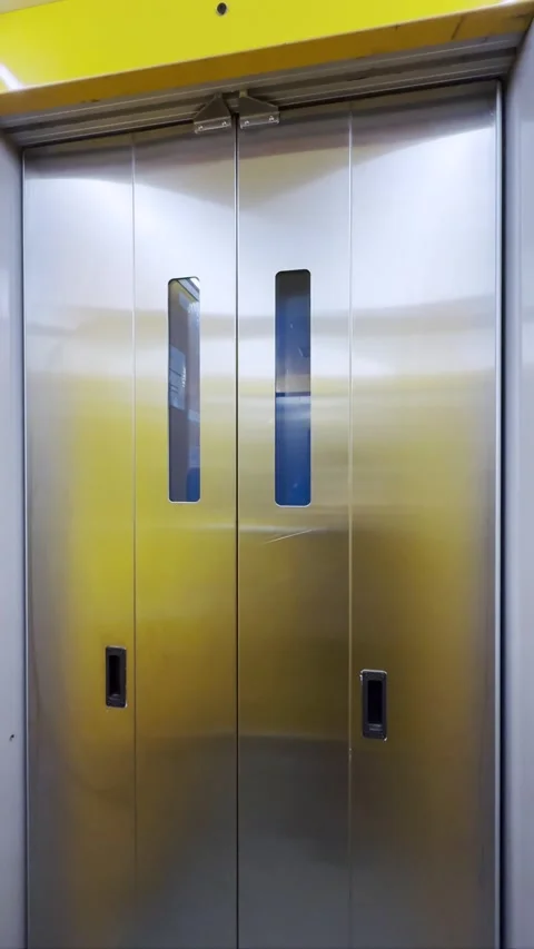 Empty elevator or lift travelling up with folding doors opening, vertical video Stock Footage 321449433