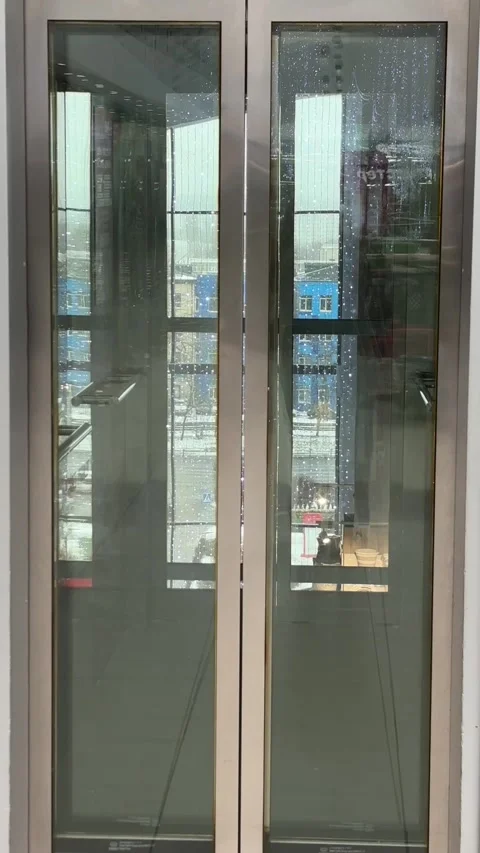 An empty elevator in a shopping mall or office building. The modern glass metal Stock Footage 325649764