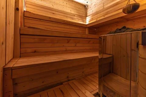Empty, empty, heated sauna with a Himalayan brick wall, wooden walls in the.. Stock Photos