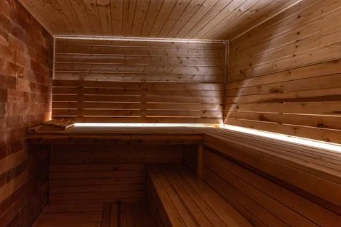 Empty, empty, heated sauna with a Himalayan brick wall, wooden walls in the.. Stock Photos