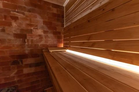 Empty, empty, heated sauna with a Himalayan brick wall, wooden walls in the.. Stock Photos