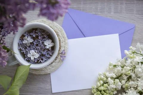 Empty envelope copy space paper note with Tasty black tea in white cup on Stock Photos