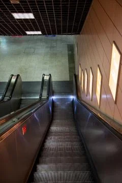 The empty escalator going down inside the building Stock Photos