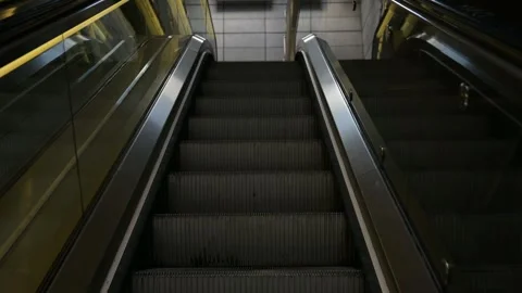 An empty escalator going up, at a metro station or inside a building. Stock Footage 329125299