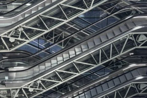 Empty escalator inside modern subway interior with geometric perspective. met Stock Photos