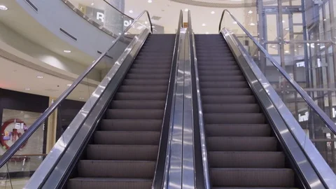 Empty escalator in mall, closed stores, empty shopping center, no people go to m Stock Footage 129358673