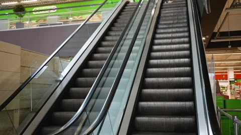 Empty escalator moving upwards in shopping mall Видео 316857938