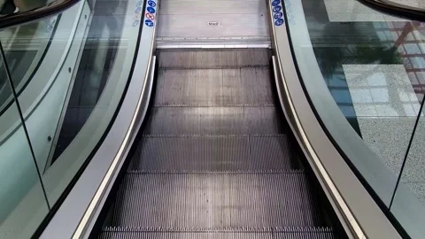 Empty escalator in operation. Shopping mall, descending escalator in first Stock Footage 333037343