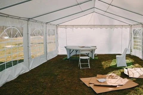 Empty Event Tent Setup with Table and Chairs Outdoors 库存照片